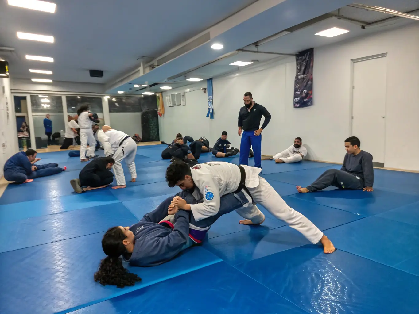A certified Judo Club Villers Cotterets instructor guiding students through a ju-jitsu technique, emphasizing the club's commitment to quality instruction and safety.
